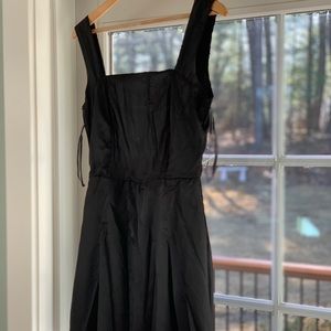 Simple black mini dress with gold chains on back